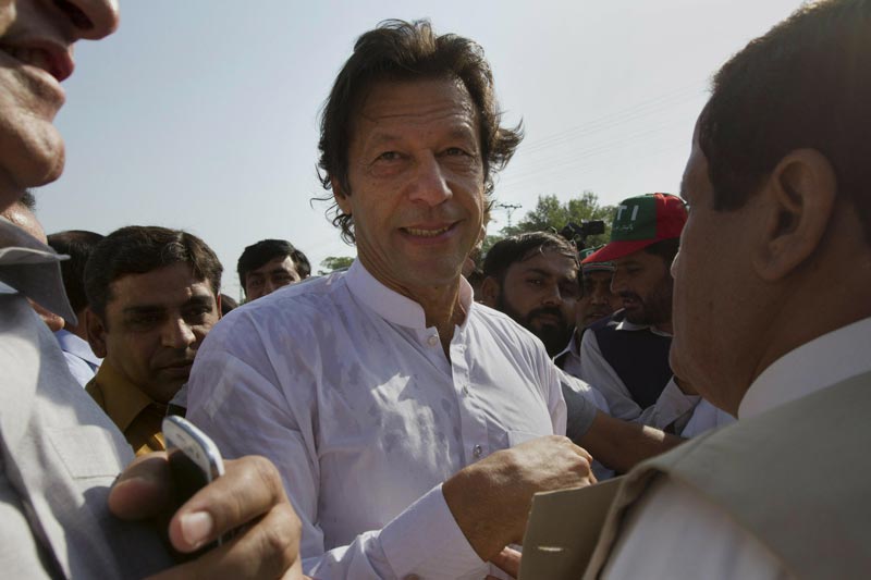 Pakistan's ex-cricket player-turned-politician Imran Khan is surrounded by his supporters as he arrives to lead what organisers are calling the "peace march," in Islamabad on Saturday October 6. (AP)