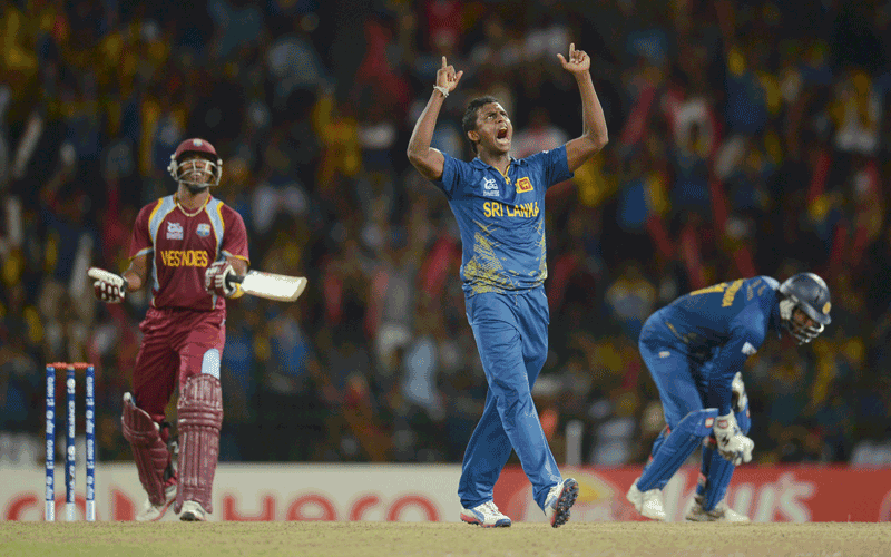 Sri Lanka's Ajantha Mendis celebrates after dismissing West Indies' Dwayne Bravo (L) during the world Twenty20 final at R Premadasa Stadium, Colombo. (REUTERS)