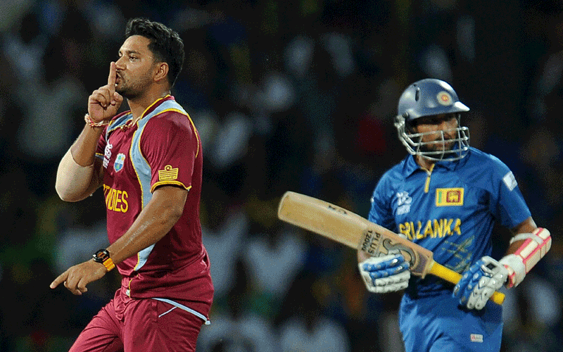 West Indies cricketer Ravi Rampaul (L) gestures as he celebrates after he dismissed Sri Lankan batsman Tillakaratne Dilshan (R) during the ICC Twenty20 Cricket World Cup's final match between Sri Lanka and West Indies at the R. Premadasa International Cricket Stadium in Colombo. (AFP)