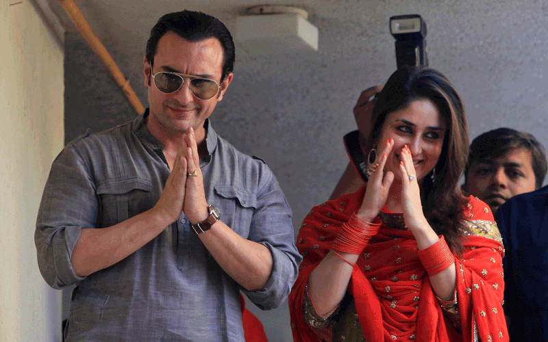 Bollywood stars Saif Ali Khan, left, and Kareena Kapoor greet waiting fans after getting married in Mumbai, India. The Press Trust of India reported the couple married Tuesday in a small official ceremony in Khan’s house in Mumbai with a few friends and family members in attendance.  (AP)