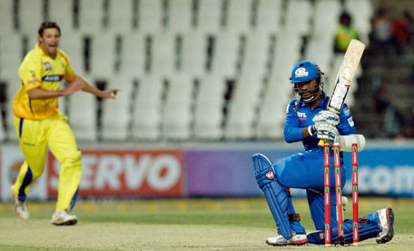 Mumbai Indians' Dinesh Karthik (right) is bowled by Chennai Supper Kings's Ben Hilfenhaus for 74 run during their Champions League Twenty20 match at the Wanderers Stadium in Johannesburg, South Africa, on October 20, 2012. (AP)