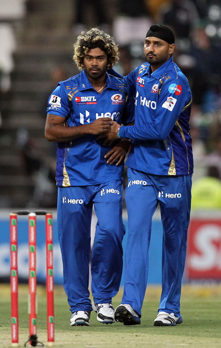 Mumbai Indians' Lasith Malinga (left) is congratulated by captain Harbhajan Singh for dismissing Chennai Super Kings'  Suresh Raina during their Champions League Twenty20 match at the Wanderers Stadium in Johannesburg, South Africa, on October 20, 2012. (AP)