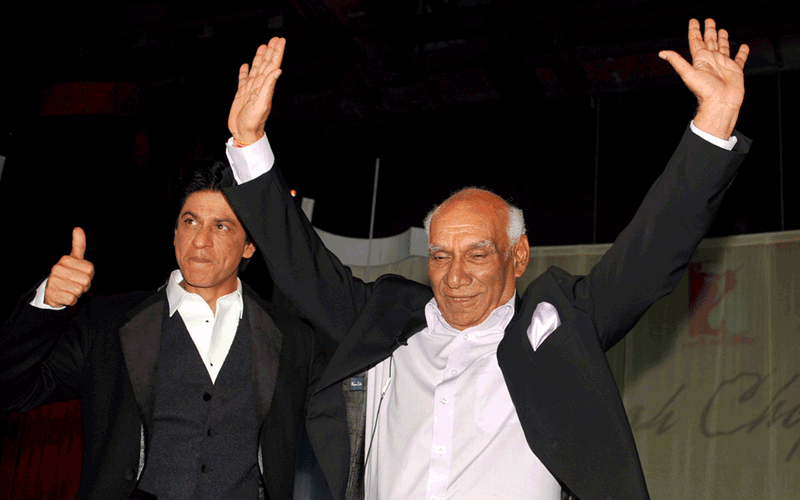In this photograph taken on September 27, 2012 Indian Veteran Bollywood filmmaker, director, screenwriter and producer Yash Raj Chopra celebrates his 81st birthday while being hugged by actor Shah Rukh Khan at a film promotion in Mumbai (AFP)