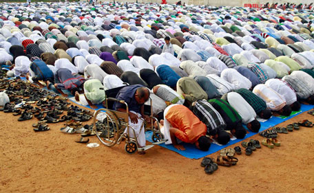Muslims offer Eid al-Adha prayers at a playground in Kochi, one of the main cities of the southern Indian state of Kerala, October 26, 2012. Muslims around the world celebrate Eid al-Adha by sacrificial slaughtering of sheep, goats, cows and camels to commemorate Prophet Abraham's willingness to sacrifice his son Ismail on God's command. Muslims in Kerala celebrated Eid al-Adha on Friday. (REUTERS)