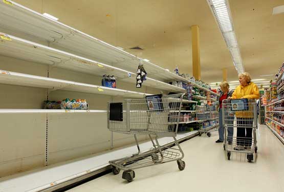 Connie of Long Beach grabs the few remaining water bottles from the shelves at the Waldbaums grocery store as Hurricane Sandy approaches on October 28, 2012 in Long Beach, New York.  (Getty Images/AFP)