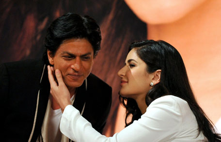 Shah Rukh Khan (L) is embraced by actress Katrina Kaif during a promotional event for the forthcoming Hindi film 'Jab Tak Hai Jaan'. (AFP)