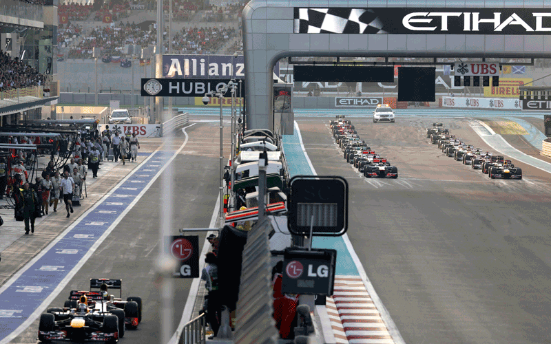 Cars line up at the start as Red Bull driver Sebastian Vettel of Germany and HRT driver Pedro de la Rosa of Spain, wait in the pit lane during the Emirates Formula One Grand Prix, at the Yas Marina racetrack, in Abu Dhabi, United Arab Emirates. (AP)