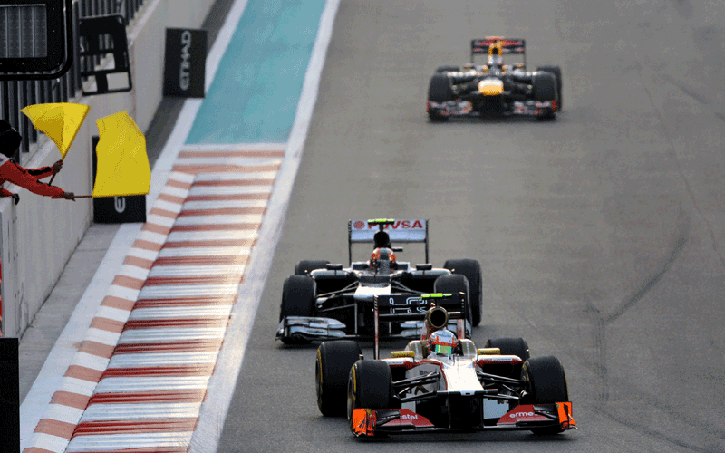 Red Bull Racing's German driver Sebastian Vettel (UP), Williams' Brazilian driver Bruno Sena and HRT F1 Team's Spanish driver Pedro Martinez de la Rosa drive at the Yas Marina circuit in Abu Dhabi during the Abu Dhabi Formula One Grand Prix. (AFP)
