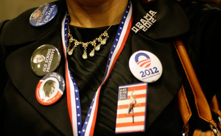 A woman wears badges in support of President Barack Obama as she attends the Presidential Election party at the U.S. Embassy in London, Wednesday, Nov.  7, 2012. (AP)