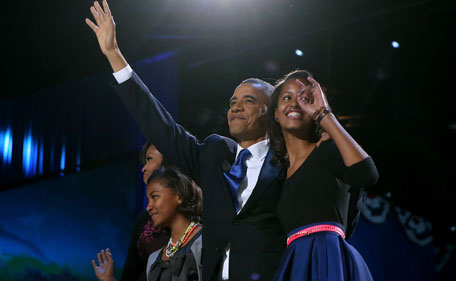 US President Barack Obama walks on stage with first lady Michelle Obama and daughters Sasha and Malia to deliver his victory speech on election night at McCormick Place November 6, 2012 in Chicago, Illinois. Obama won reelection against Republican candidate, former Massachusetts Governor Mitt Romney. (AFP)