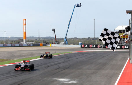 McLaren Mercedes driver Lewis Hamilton of Britain takes the chequered flag to win the Formula One US Grand Prixat the Circuit of the Americas on Nov. 18, 2012, in Austin, Texas. (AP)