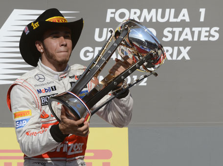 Vodafone McLaren Mercedes driver Lewis Hamilton of Britain celebrates on the podium after winning the United States Formula One Grand Prix at the Circuit of the Americas on November 18, 2012 in Austin, Texas. (AFP)