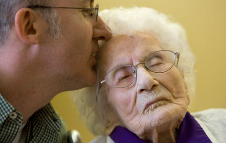 In this March 10, 2011 file photo, Besse Cooper, 114, right, receives a kiss from her grandson Paul Cooper, 42, during a ceremony in which Guinness World Records recognizes her as the word's oldest living person, at the nursing home where she lives in Monroe, Ga. Besse Cooper, the woman who was listed as the world's oldest person has died Tuesday, Dec. 4, 2012 in a Georgia nursing home at age 116, according to her son Sidney Cooper. (AP)