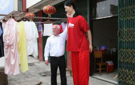 File photo: Georg Wessels, a German maker of outsize shoes, chats with Yao Defen, believed to be the tallest woman in the world. (REUTERS)