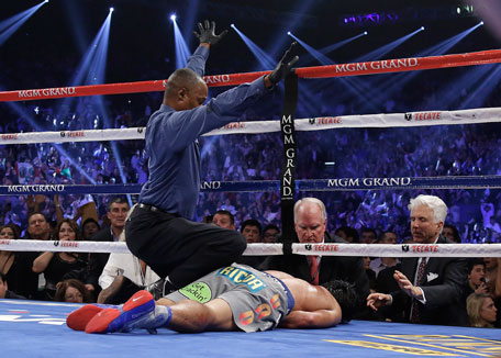 Referee Kenny Bayless calls the fight over as he kneels over Manny Pacquiao after he was knocked out by Juan Manuel Marquez during their WBO world welterweight fight on Dec. 8, 2012, in Las Vegas. (AP)