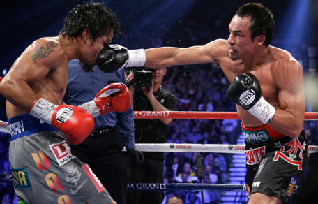 Juan Manuel Marquez lands a right to the head of Manny Pacquiao during their WBO world welterweight fight on , Dec. 8, 2012, in Las Vegas. (AP)