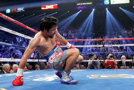 Manny Pacquiao of the Philippines rises from the canvas after being knocked down by Juan Manuel Marquez of Mexico in the third round of their welterweight fight at the MGM Grand Garden Arena in Las Vegas, Nevada December 8, 2012. (REUTERS)