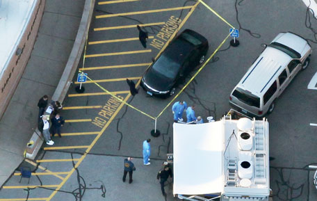 Responders gather at the scene of a mass shooting at Sandy Hook Elementary School with police tape surrounding a vehicle on December 14, 2012 in Newtown, Connecticut. Twenty-seven are dead, including 20 children, after a gunman identified as Adam Lanza in news reports, opened fire in the school. Lanza also reportedly died at the scene. (Getty Images/AFP)