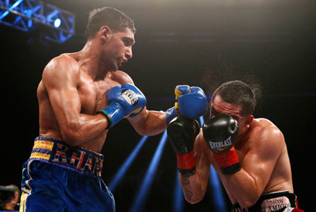 Amir Khan of Britain (left) lands a punch on Carlos Molina during their WBC Silver Super Lightweight title bout in Los Angeles, California, onn December 15, 2012. (REUTERS)