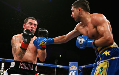 Amir Khan (right) lands a punch on Carlos Molina during their WBC Silver Super Lightweight title bout in Los Angeles, California, on December 15, 2012. (REUTERS)
