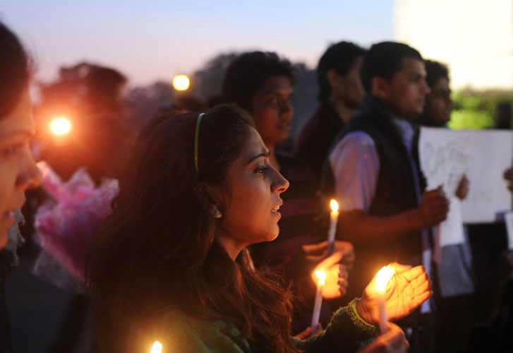 Indian students and activists carry candles at India Gate during a protest following the gang-rape of a student in New Delhi on December 19 (AFP)