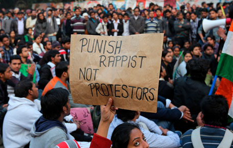 A demonstrator holds a placard during a protest in New Delhi December 24, 2012. Indian authorities throttled movement in the heart of the capital on Monday, shutting roads and railway stations in a bid to restore law and order after police fought pitched battles with protesters enraged by the gang rape of a young woman. (REUTERS)