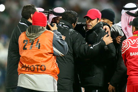UAE coach Mahdi Ali (red cap) is congratulated after his team beat Kuwait 1-0 during the semifinal of the 21st Gulf Cup in Manama, on January 15, 2013. (AFP)