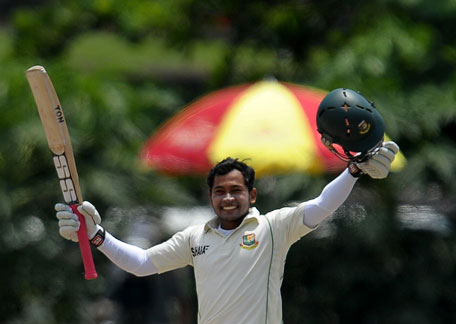 Bangladeshi captain Mushfiqur Rahim raises his bat and helmet in celebration after scoring a double century  during the fourth day of the first Test against Sri Lanka at the Galle International Cricket Stadium in Galle on March 11, 2013. (AFP)