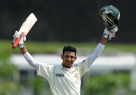 Bangladesh's Nasir Hossain raises his bat and helmet in celebration after scoring a century during the fourth day of the first Test against Sri Lanka at the Galle International Cricket Stadium in Galle on March 11, 2013. (AFP) PHOTO/ LAKRUWAN WANNIARACHCHI