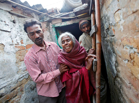 The brother, mother and father (L-R) of Ram Singh, the driver of the bus in which a young woman was gang-raped and fatally injured three months ago, leave their house at Ravi Das camp in New Delhi March 11, 2013. Singh hanged himself in his jail cell on Monday, prison authorities said, but his family and lawyer said they suspected "foul play". (REUTERS)