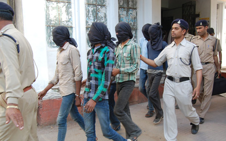 Indian policemen escort gang rape suspects to be produced in court in Datia, about 75 kms from Gwalior in central Madhya Pradesh state. (AFP)