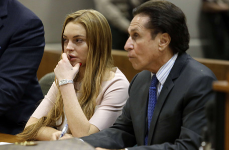 Actress Lindsay Lohan and attorney Mark Heller listen at a hearing in Los Angeles Superior Court on March 18, 2013. The hearing is to determine whether Lohan returns to jail or averts a trial on charges that she lied to police over a June 2012 car crash that briefly sent her to the hospital. Lohan has pleaded not guilty to three misdemeanor charges filed after the accident - reckless driving, lying to police and obstructing officers from performing their duties. (AFP)
