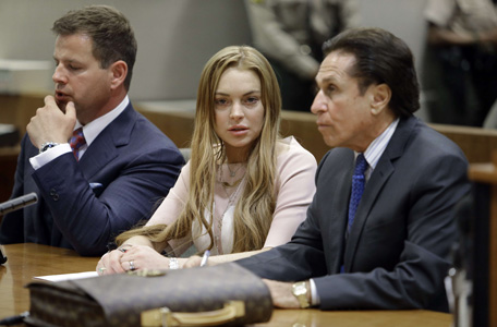 Actress Lindsay Lohan and attorneys Mark Heller (R) and Anthony Falangetti (L) appear at a hearing in Los Angeles Superior Court on March 18, 2013. The hearing is to determine whether Lohan returns to jail or averts a trial on charges that she lied to police over a June 2012 car crash that briefly sent her to the hospital. Lohan has pleaded not guilty to three misdemeanor charges filed after the accident - reckless driving, lying to police and obstructing officers from performing their duties. (AFP)