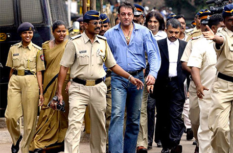 Policemen escort actor Sanjay Dutt as he comes out of the Terrorist And Disruptive Activities (Protection) Act (TADA) court during the first day of verdicts in the 1993 bomb attacks case in Mumbai on 12 September 2006. (AFP)