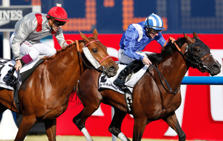 Christophe Soumillon (L), riding Al Mamun Monlau of France, races towards the finish line against Paul Hanagan, riding Versac Py of France, during the first race "Dubai Kahayla Classic" of the Dubai World Cup at the Meydan Racecourse in Dubai March 30, 2013. (REUTERS)
