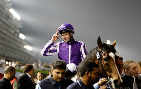Joseph O'Brien, riding St Nicholas Abbey of Ireland, celebrates after winning the eighth race "Dubai Sheema Classic" during the Dubai World Cup at the Meydan Racecourse in Dubai March 30, 2013. (REUTERS)