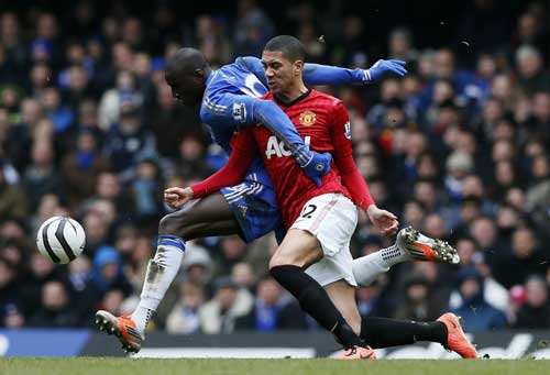 Chelsea's Demba Ba (left) challenges Manchester United's Chris Smalling during their English FA Cup quarter-final replay soccer match at Stamford Bridge in London April 1, 2013. (REUTERS)