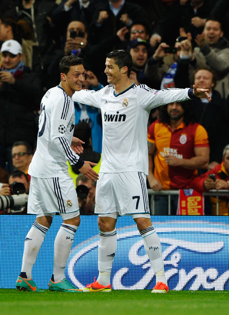 Cristiano Ronaldo (right) of Real Madrid celebrates scoring the opening goal with Mesut Ozil during the UEFA Champions League quarter-final first leg match against Galatasaray at Estadio Santiago Bernabeu on April 3, 2013 in Madrid, Spain. (GETTY)