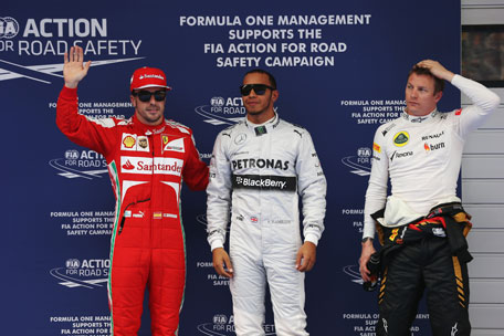 Pole sitter Lewis Hamilton (centre) of Mercedes GP celebrates in parc ferme alongside second placed Kimi Raikkonen (right) of Lotus and third placed Fernando Alonso of Ferrari following qualifying for the Chinese Formula One Grand Prix at the Shanghai International Circuit on April 13, 2013 in Shanghai, China. (GETTY)