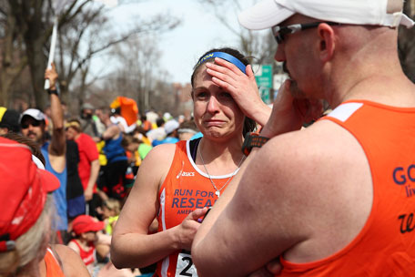 A runner reacts near Kenmore Square after two bombs exploded during the 117th Boston Marathon on April 15, 2013 in Boston, Massachusetts. (GETTY)