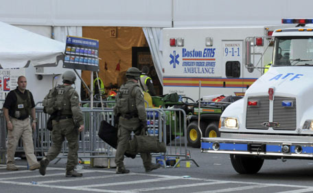 Agents from several federal agencies including the FBI and ATF arrive on scene after explosions near the finish line of the Boston Marathon in Boston, Massachusetts April 15, 2013. U.S. investigators led by the FBI are poring over video and photographs from the widely watched Boston Marathon for clues to determine who is responsible for two bombs that exploded near the finish line on Monday, killing three people and injuring more than 100, officials said. (REUTERS)