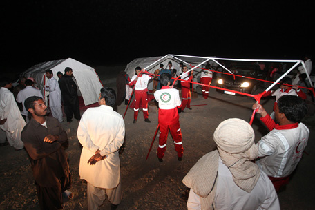 Iranian red crescent workers erect tents for victims of an earthquake in the city of Saravan, in Sistan-Beluchistan province, in south-eastern Iran. (AFP)