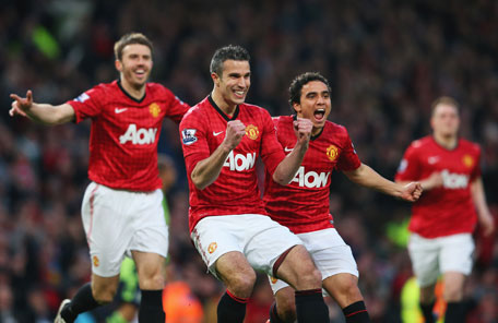 Robin van Persie of Manchester United celebrates scoring the opening goal with Michael Carrick and Rafael during the Barclays Premier League match against Aston Villa at Old Trafford on April 22, 2013 in Manchester, England. (GETTY)