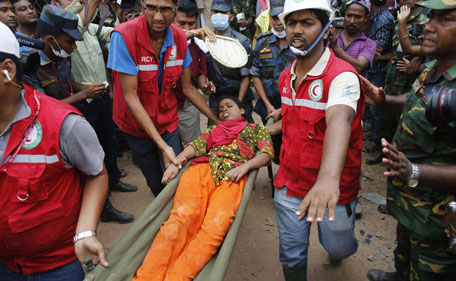 Rescue workers carry a survivor, who was trapped inside the rubble of the collapsed Rana Plaza building, in Savar, 30 km (19 miles) outside Dhaka April 25, 2013.  The death toll from a building collapse in Bangladesh has risen to 160 and could climb higher, police said on Thursday, with people trapped under the rubble of a complex that housed garment factories supplying retailers in Europe and North America. (REUTERS)