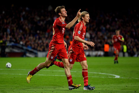 Thomas Muller (left) of Bayern Munich celebrates with teammate Anatoliy Tymoshchuk after scoring his team's third goal during the UEFA Champions League semifinal second leg at Nou Camp on May 1, 2013 in Barcelona, Spain. (GETTY)