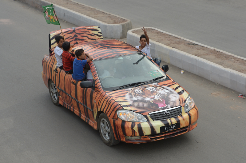 Supporters of Pakistan Muslim League Nawaz (PML-N) drive through the streets during the general election in Rawalpindi on May 11, 2013.  Millions of Pakistanis turned out to vote in landmark elections on Saturday, defying deadly Taliban attacks to take part in an historic democratic transition for the nuclear-armed state. (AFP)