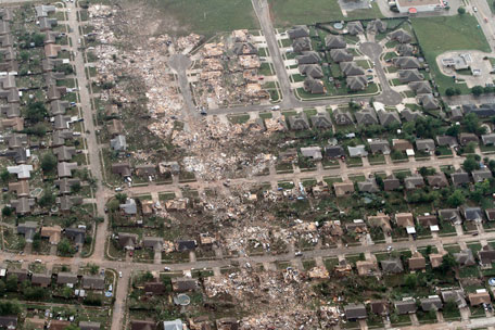 This aerial photo shows the remains of homes hit by a massive tornado in Moore, Okla., Monday May 20, 2013. A tornado roared through the Oklahoma City suburbs Monday, flattening entire neighborhoods, setting buildings on fire and landing a direct blow on an elementary school. (AP)