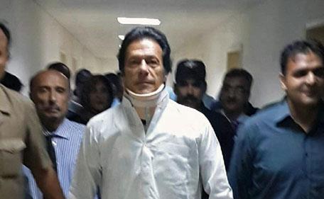 This handout photograph released by the Shaukat Khanum Memorial Hospital (SKMH) shows Pakistani politician Imran Khan, the head of Pakistan Tehreek-e-Insaaf (PTI) party, leaving the hospital in Lahore on May 22, 2013 . Khan left hospital on May 22, two weeks after breaking bones in his back in a fall at a rally for the country's general election, where his party scored a major breakthrough. The 60-year-old was ordered to remain immobile in bed after he fractured vertebrae and a rib in a dramatic tumble from a hoist lifting him to a stage just days before the May 11 general election. (AFP)