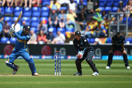 Kumar Sangakkara (left) of Sri Lanka plays to the offside as wicketkeeper Luke Ronchi of New Zealand looks on during the Group A ICC Champions Trophy match bat the SWALEC Stadium on June 9, 2013 in Cardiff, Wales. (GETTY)