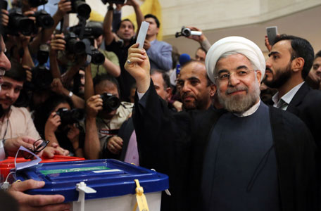 Iranian moderate presidential candidate, Hassan Rohani, casts his vote at a polling station in Tehran on June 14, 2013. (AFP)
